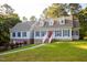 Charming two-story home featuring blue shutters, dormer windows, and a well-maintained lawn at 7405 Chickadee Ct, Sanford, NC 27332
