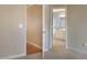 View of a hallway connecting rooms with doors, including one to a bathroom at 7405 Chickadee Ct, Sanford, NC 27332