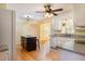 Kitchen with white cabinets, granite countertops, hardwood floors, and an island at 7405 Chickadee Ct, Sanford, NC 27332