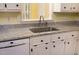 Close-up of kitchen sink with stainless steel faucet and light granite countertops at 7405 Chickadee Ct, Sanford, NC 27332