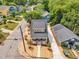 An aerial view of a home featuring a spacious driveway and a manicured front yard at 801 N Elm St, Durham, NC 27701