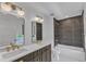 Beautifully renovated bathroom with double sinks, dark cabinets, and modern tile work in shower at 801 N Elm St, Durham, NC 27701