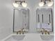 Bathroom with double sinks, white counters and walls, and matching stylish mirrors and light fixtures at 801 N Elm St, Durham, NC 27701
