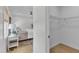 Light and airy bedroom view through closet door, featuring white walls and wood-look floors at 801 N Elm St, Durham, NC 27701