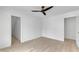 A spacious bedroom with two entryways and a ceiling fan at 801 N Elm St, Durham, NC 27701