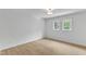Bedroom with light wood floors, recessed lighting, and two windows at 801 N Elm St, Durham, NC 27701