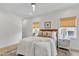 Bright bedroom featuring wood flooring, ceiling fan, and a comfortably made bed with many pillows at 801 N Elm St, Durham, NC 27701