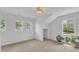 Bright bonus room with wood floors, three windows, recessed lighting, and a peekaboo storage area at 801 N Elm St, Durham, NC 27701
