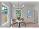 Bright breakfast nook features two chairs, natural light, a view to the exterior, and modern lighting at 801 N Elm St, Durham, NC 27701