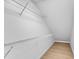 A walk-in closet features built-in shelving and light wood flooring at 801 N Elm St, Durham, NC 27701