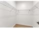 Walk-in closet with metal shelving, light wood floor, and white walls at 801 N Elm St, Durham, NC 27701