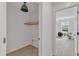 Hallway view into a light-filled room; secondary closet featuring storage rack at 801 N Elm St, Durham, NC 27701