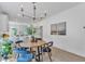 Elegant dining area featuring a modern chandelier and an open floor plan with abundant natural light at 801 N Elm St, Durham, NC 27701