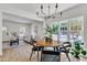 Well-lit dining area with wood table, open to the living room, and hardwood floors at 801 N Elm St, Durham, NC 27701