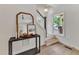 Inviting entryway with staircase, table and mirror, and natural light at 801 N Elm St, Durham, NC 27701