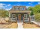Charming green home featuring a welcoming front porch and well-manicured landscaping at 801 N Elm St, Durham, NC 27701