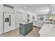 Spacious kitchen features white cabinets, stainless steel appliances, and center island with seating at 801 N Elm St, Durham, NC 27701
