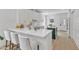 Bright, open kitchen featuring white cabinets, quartz countertops, an island with seating and modern stainless steel appliances at 801 N Elm St, Durham, NC 27701