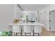 Bright open kitchen with white cabinets, quartz countertops, and upholstered seating at 801 N Elm St, Durham, NC 27701