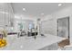 Bright, open kitchen featuring white cabinets, quartz countertops, and stainless steel appliances at 801 N Elm St, Durham, NC 27701
