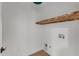 Bright laundry room features wood floors, a wooden shelf, and washer and dryer hookups at 801 N Elm St, Durham, NC 27701