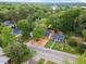 An aerial view of a home nestled amongst lush trees and landscaping within a vibrant neighborhood at 805 Camden Ave, Durham, NC 27701