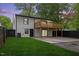 Renovated home with a wooden deck, large concrete patio, and a well-manicured lawn, perfect for outdoor entertaining at 805 Camden Ave, Durham, NC 27701