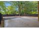 An ample concrete patio highlights a backyard with fresh landscaping and modern fence at 805 Camden Ave, Durham, NC 27701