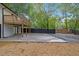 An ample concrete patio and wooden deck highlight a backyard with fresh landscaping and modern fence at 805 Camden Ave, Durham, NC 27701