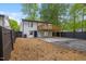 This backyard features a wooden deck, modern fence, and a large concrete patio with fresh landscaping at 805 Camden Ave, Durham, NC 27701