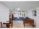 Basement featuring entertainment area with foosball table, jukebox, and a comfortable blue sofa at 805 Camden Ave, Durham, NC 27701