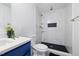 A modern bathroom with a stylish vanity, marble tile shower, and sleek fixtures at 805 Camden Ave, Durham, NC 27701