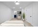 An airy bedroom offers a TV, plant, and easy access to an adjacent bathroom at 805 Camden Ave, Durham, NC 27701