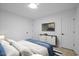 A bright bedroom with warm floors, a TV and two closets for plenty of storage at 805 Camden Ave, Durham, NC 27701