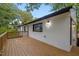A wooden deck extending from the rear of a white brick home offers outdoor living at 805 Camden Ave, Durham, NC 27701