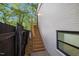 Side view of white brick house with wooden staircase leading to an upper level at 805 Camden Ave, Durham, NC 27701