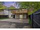 Two-story white brick home with wooden deck and a lower-level patio; fenced backyard at 805 Camden Ave, Durham, NC 27701
