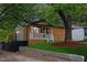 Charming home features a covered porch, wood siding, and a mature shade tree at 805 Camden Ave, Durham, NC 27701