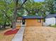 Charming single story home featuring a minimalist landscape, concrete path to front door, and modern wood facade at 805 Camden Ave, Durham, NC 27701