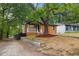Charming home features a covered porch, wood siding, and a mature shade tree at 805 Camden Ave, Durham, NC 27701