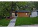Charming home features a covered porch, wood siding, green lawn, and mature shade tree at 805 Camden Ave, Durham, NC 27701