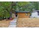 Charming home features a covered porch, wood siding, and a mature shade tree at 805 Camden Ave, Durham, NC 27701
