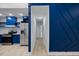 The hallway features a bold blue accent wall with geometric molding and leads to the kitchen at 805 Camden Ave, Durham, NC 27701
