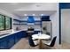 Bright kitchen features blue cabinets, stainless steel appliances, and a cozy dining area at 805 Camden Ave, Durham, NC 27701