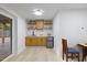 Basement kitchenette with custom cabinets, marble backsplash, open shelves, and stainless steel refrigerator at 805 Camden Ave, Durham, NC 27701