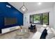 Inviting living room featuring an oval-windowed front door, modern decor, and a geometric blue accent wall at 805 Camden Ave, Durham, NC 27701