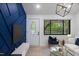 Inviting open-plan living room featuring an oval-windowed front door and a geometric blue accent wall at 805 Camden Ave, Durham, NC 27701