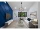 Open-plan living room featuring modern decor and a geometric blue accent wall at 805 Camden Ave, Durham, NC 27701