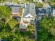 Backyard aerial view features a pristine lawn, stone patio, and an elegant driveway leading to a well-maintained home at 909 N Gregson St, Durham, NC 27701
