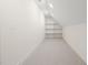 Bright attic storage space with built-in shelving and neutral carpeting; perfect for organization at 909 N Gregson St, Durham, NC 27701